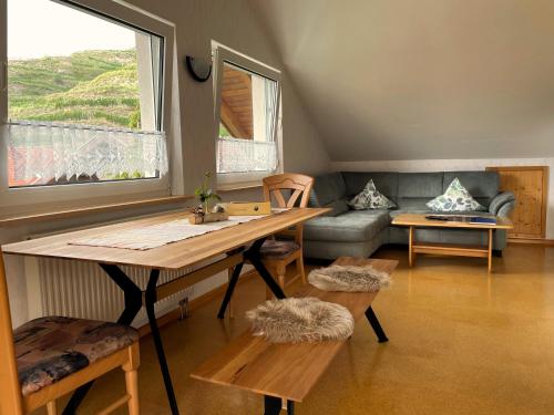 a living room with a table and a couch at Weingut & Straußwirtschaft Vogel in Vogtsburg