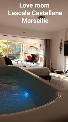 a living room with a large pool in the middle of a house at Love room l'escale Castellane in Marseille