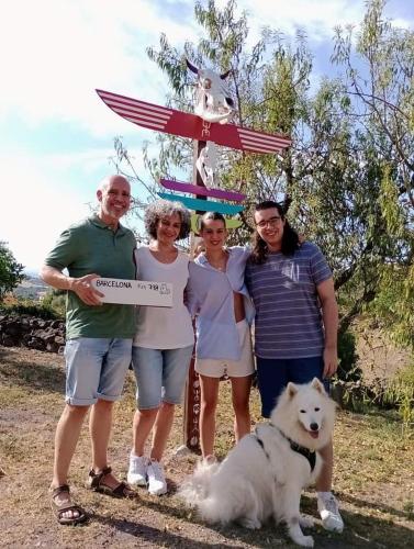 a group of people standing in front of a sign with a dog at Casa Vacanze Janas in Ruinas