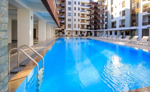 a large blue swimming pool in a building at Lemaiyan Suites in Naivasha