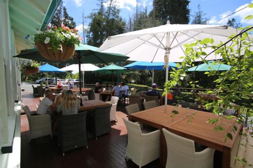 a group of people sitting at tables with umbrellas at Okoroire Hot Springs Hotel in Okoroire