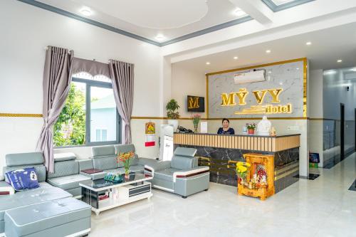 a living room with a couch and a fireplace at Hotel Mỹ Vy in Tánh Linh