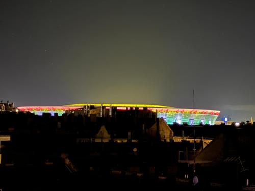 a view of a soccer stadium at night at Rooftop City Residence in Budapest