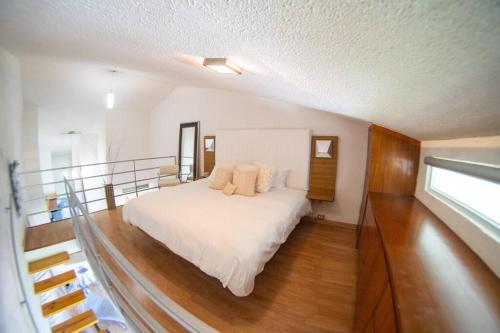 a bedroom with a large bed in a house at Modern Loft Style Apt w/ Beautiful View w/ Pool in Rio Grande