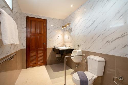 a bathroom with a toilet and a sink at Capitel Rama 4 in Bangkok