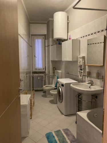 a bathroom with a sink and a washing machine at Fiore di langa in Alba