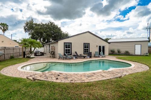 a backyard with a swimming pool and a house at Royal Equestrian Haven a Luxury Paradise Escape with Pool in Royal Palm Beach