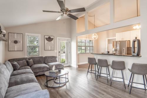a living room with a couch and a kitchen at Royal Equestrian Haven a Luxury Paradise Escape with Pool in Royal Palm Beach