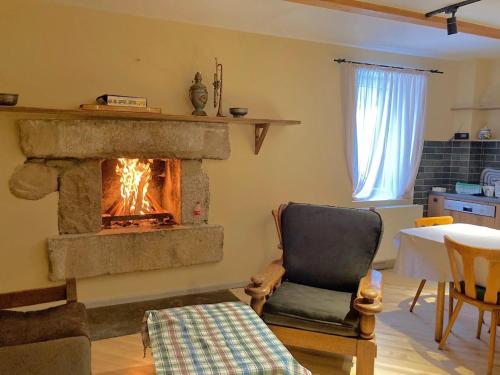 a living room with a fireplace and a chair at Snowpeak Chalet Gudauri in Gudauri