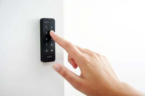 a person pressing a remote control on a wall at Luxurious 35m2 Designer Studio - R51A in Eindhoven