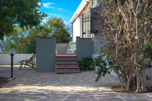 ein Haus mit einer Treppe davor in der Unterkunft I Mandorli in Porto Conte