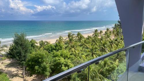 a view of the beach from the balcony of a condo at Beach Bliss in Trincomalee