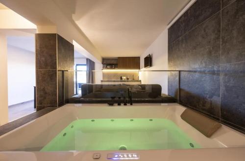 a large bath tub in a room with a couch at La BriSa in Capo dʼOrlando