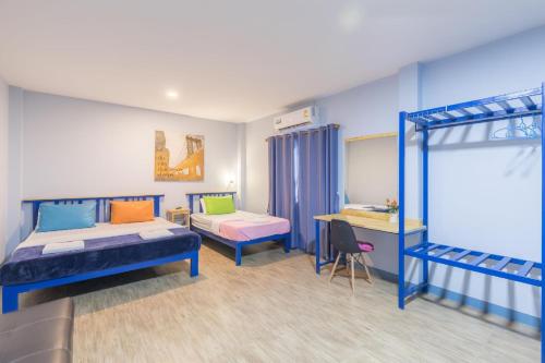 a bedroom with two bunk beds and a desk at Blueplace บลูเพลส in Ban Talat Rangsit