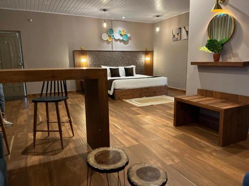 a bedroom with a bed and a table and a stool at Misty Courtyard Resort in Chinnakanal
