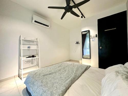 a bedroom with a bed and a ceiling fan at BNB Cozy Homestay @ Cyberjaya in Cyberjaya