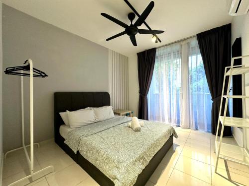 a bedroom with a bed and a ceiling fan at BNB Cozy Homestay @ Cyberjaya in Cyberjaya