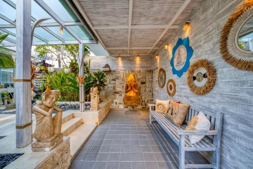 a lobby of a building with statues on the wall at Bali Cosy Villas Seminyak in Legian
