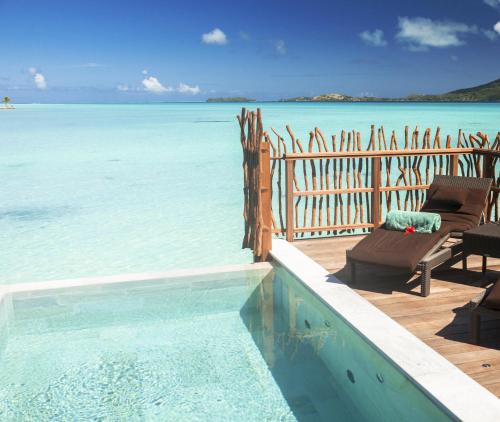 a swimming pool with a view of the ocean at InterContinental Bora Bora & Thalasso Spa by IHG in Bora Bora