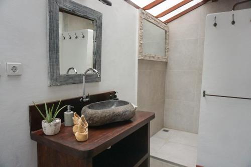 y baño con lavabo y espejo. en Villa Maiya, en Gili Air