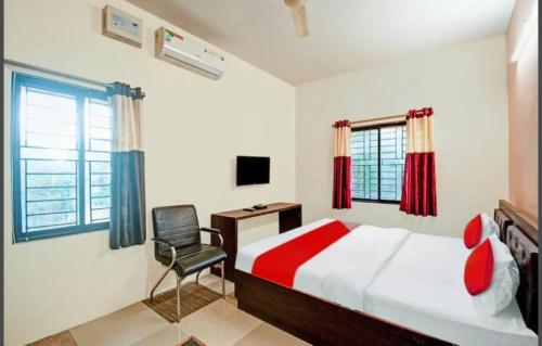 a bedroom with a bed and a desk and a chair at SR HOME STAY in Bhubaneshwar
