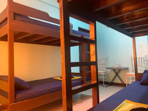 a bunk bed in a room with a ladder at Ahras Place in Coron