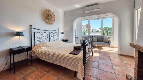een slaapkamer met een bed en een woonkamer bij Costacabana - Villa Madonna in Lloret de Mar