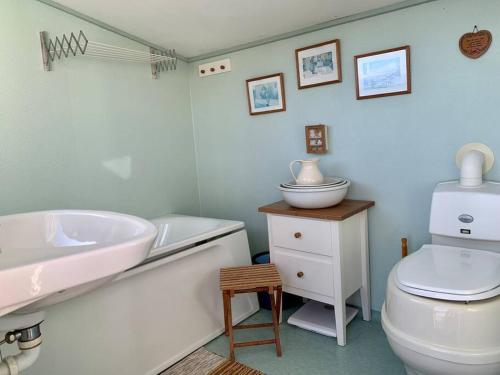a bathroom with a white sink and a toilet at Flemma Gård By the lake in Vreta Kloster