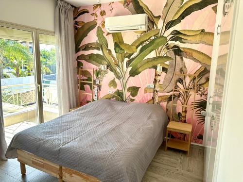 a bedroom with a bed with a plant wall at Leto beach house in Limassol