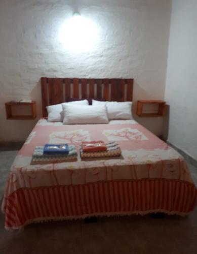a bedroom with a large bed with two items on it at Armonia un lugar para Descansar in Formosa