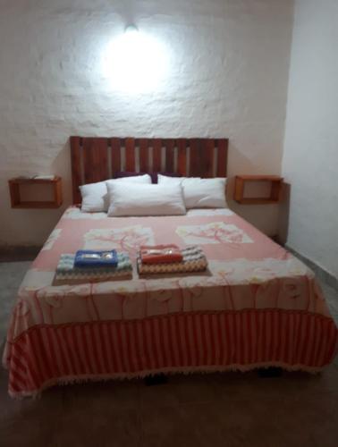 Un dormitorio con una cama con dos libros. en Armonia un lugar para Descansar en Formosa