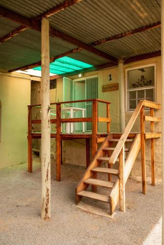 a building with a bunk bed and a staircase at De Rusty Farm in De Rust