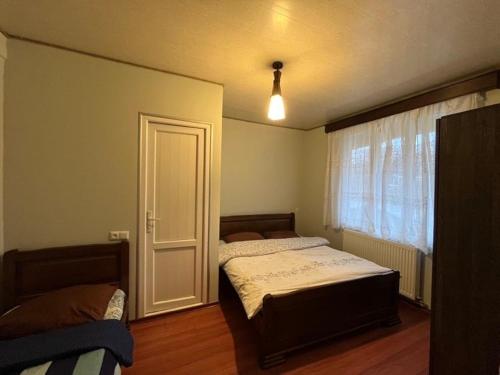 a bedroom with two beds and a window at Mака и Сулико in Batumi