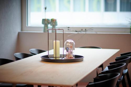 a table with a candle and a glass dome on it at Hotel Balga Natur- und Bikehotel in Balgach