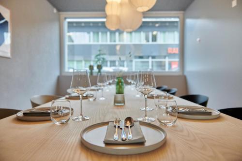 a table with wine glasses and silverware on it at Hotel Balga Natur- und Bikehotel in Balgach