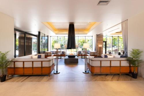 a living room with two beds and a couch at AQA Hotel Premium in Saku