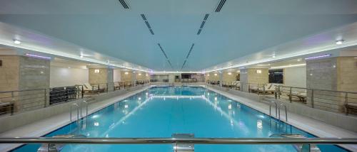 a large swimming pool in a building at Grand Millennium Konya in Konya