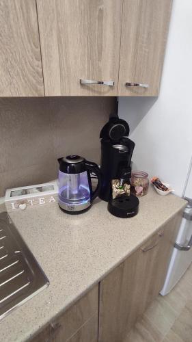 a coffee maker on a counter in a kitchen at Noua Apartment in Braşov