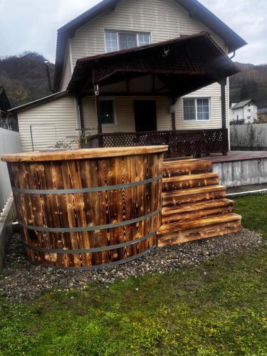 a wooden fence in front of a house at Casa Ary in Băile Olăneşti