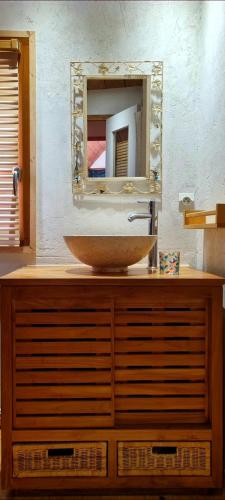 La salle de bains est pourvue d'un lavabo et d'un miroir sur une commode. dans l'établissement Home Sweet Home, à Brest