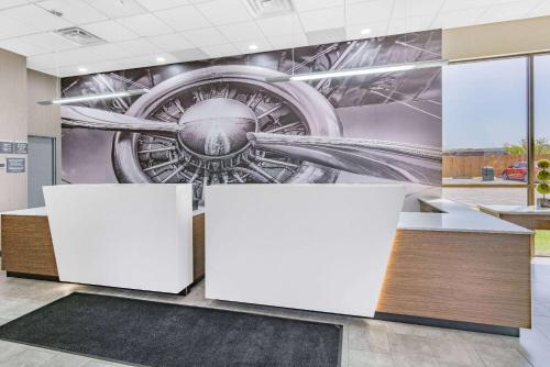 a mural of an airplane on a wall in a lobby at Wingate by Wyndham Wichita Airport in Wichita