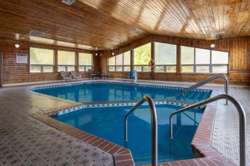 a large indoor pool in a building with windows at Travelodge by Wyndham Merrill in Merrill