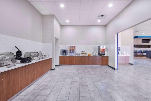 an empty lobby of a restaurant with a counter at Hawthorn Extended Stay by Wyndham Wichita Airport in Wichita