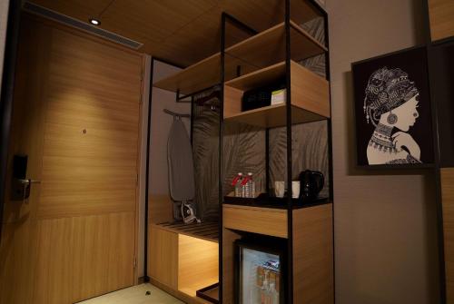 a room with a room with a tv and a door at Ramada Encore by Wyndham Bareilly Civil Lines in Bareilly