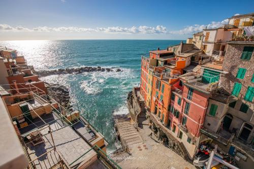 an aerial view of the ocean between buildings at Alla Marina Affittacamere in Riomaggiore