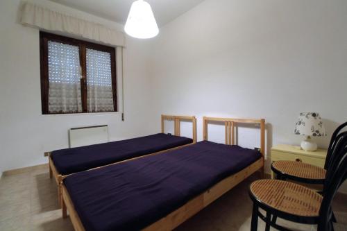 1 Schlafzimmer mit 2 Betten, einem Tisch und Stühlen in der Unterkunft Casa Mare Vienna in Follonica