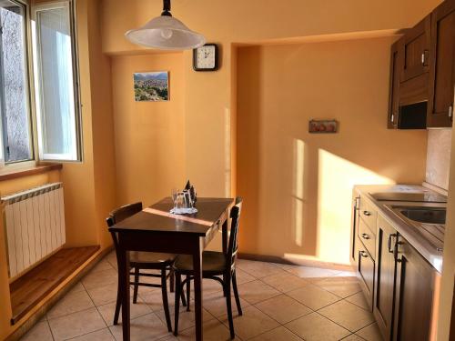 a kitchen with a table and chairs in a room at Agriturismo Edoardo Patrone in Domodossola