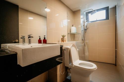 a bathroom with a sink and a toilet at Stylish Loft Duplex Sunway Grid by Our Stay in Kampong Pendas