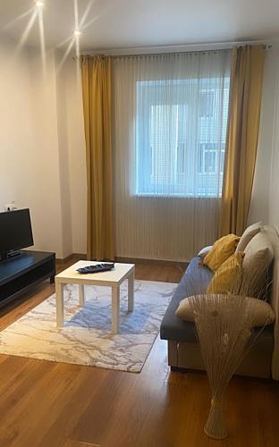 a living room with a couch and a coffee table at DMT Apartament regim hotelier Rin in Bucharest