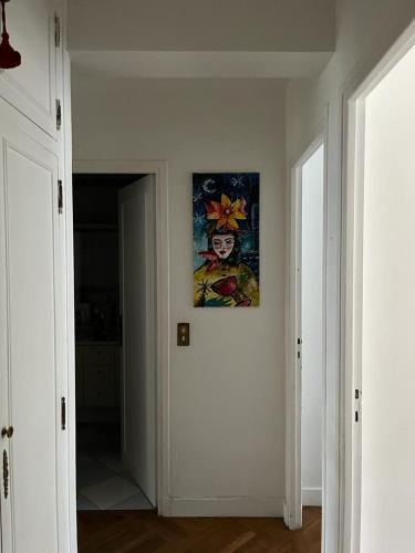 a hallway with a painting hanging on the wall at Bd du Lycée-Rue d'Issy in Vanves
